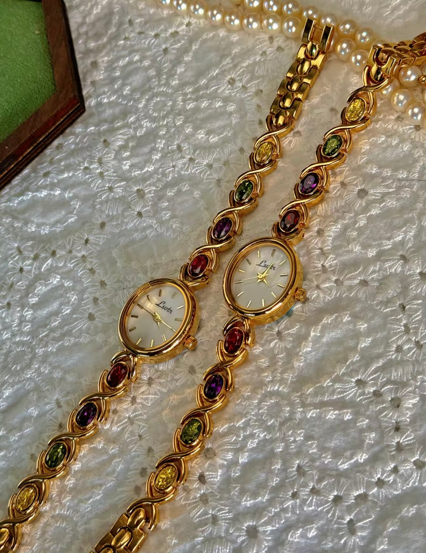 Gold Oval Quartz Face Embedded Coloured Gemstone Watch