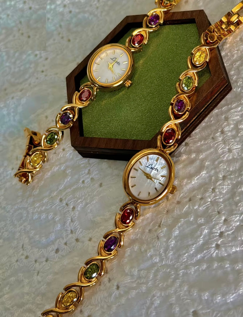 Gold Oval Quartz Face Embedded Coloured Gemstone Watch