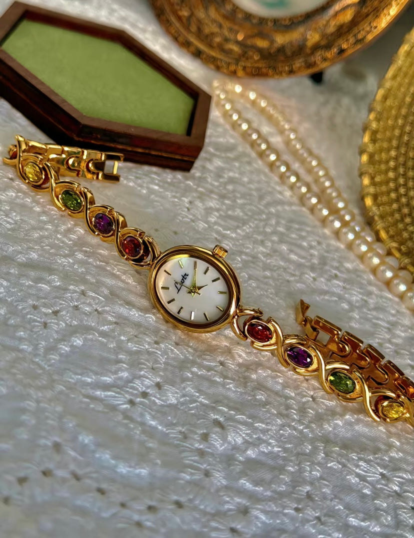 Gold Oval Quartz Face Embedded Coloured Gemstone Watch