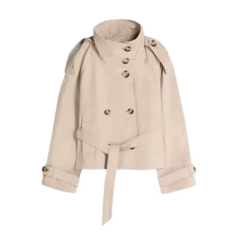 A beige double-breasted trench jacket with a high stand-up collar, matching waist tie belt, and gold-tone buttons, shown against a plain white background.
