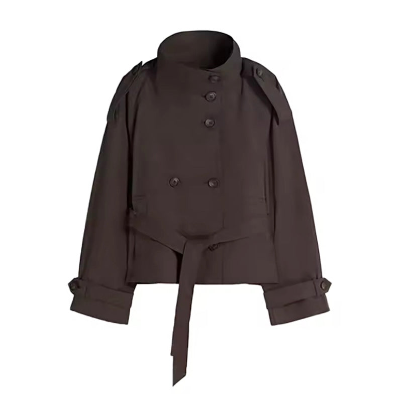 A dark brown cropped trench jacket with a high stand collar, double-breasted front, shoulder epaulets, and a self-tie belt at the waist, shown against a plain white background.